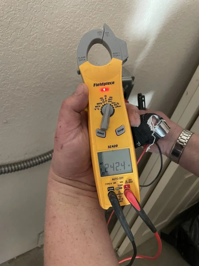 Voltage testing with clamp meter during Whole House Surge Protector in Arlington